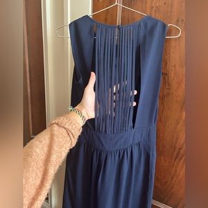 Navy blue mid length sleeveless dress with back detail. Size Small.
